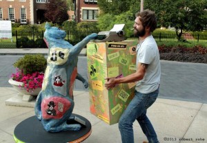 Photo by Rob Rohe Henry Goldkamp, St. Louis' own busking poet, helps a cat sculpture type out its thoughts on the streets of the Central West End. 