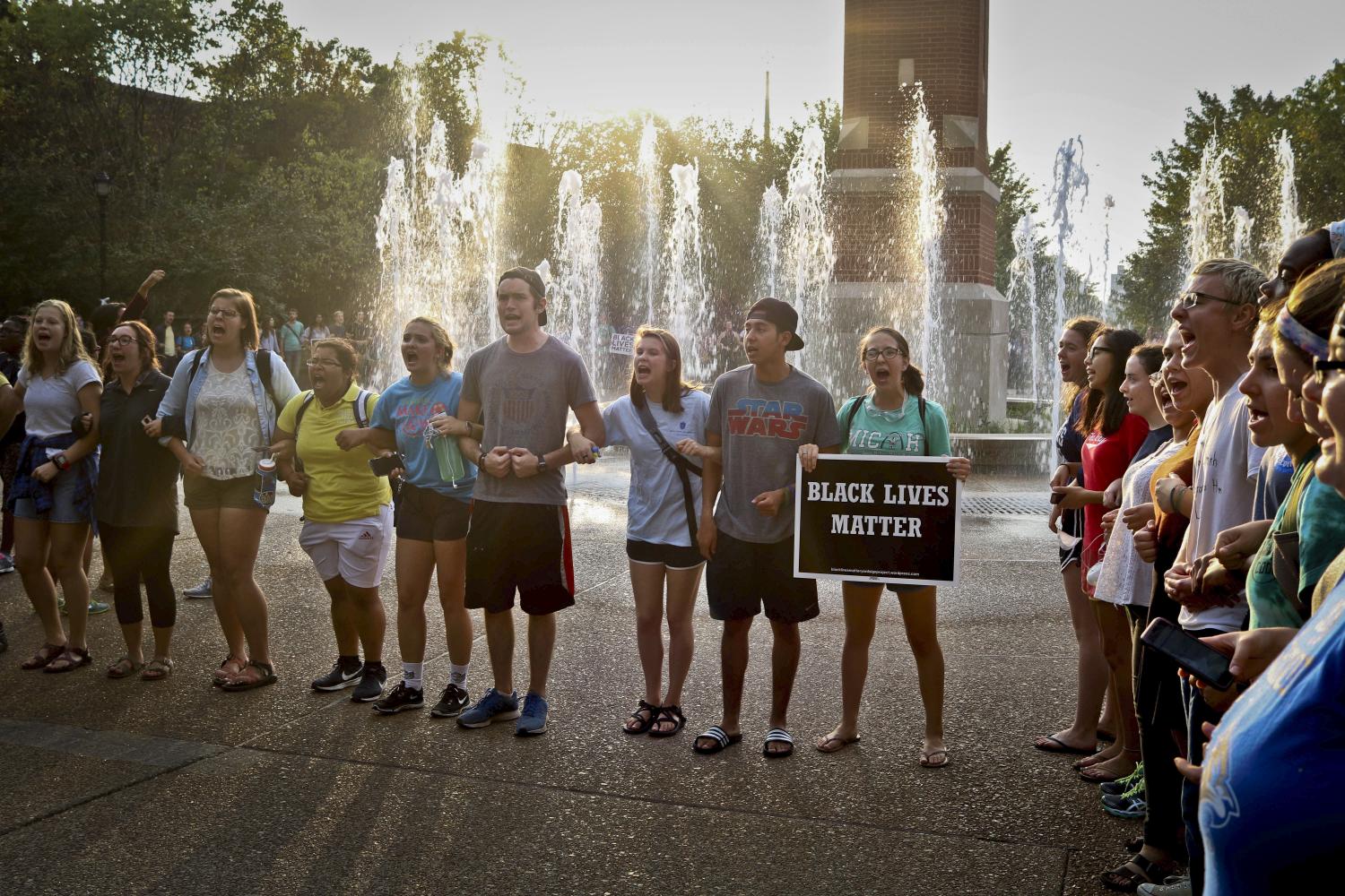 SLU students gather around the clock tower to voice their dissent in reaction to the not-guilty verdict in the trial of former St. Louis police officer Jason Stockley.