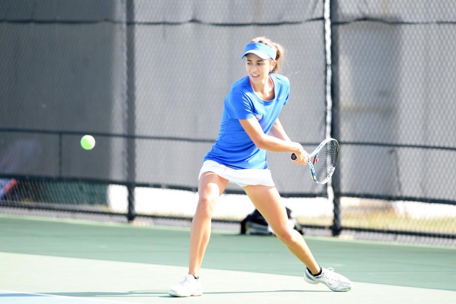 Sophomore Mariluz Rojo stares down the ball before hitting forehand.