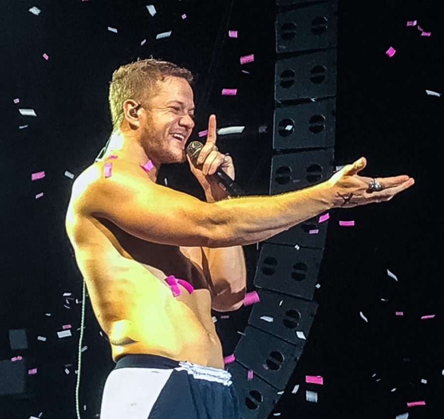 Imagine Dragons singer Dan Reynolds sings to the crowd in a sea of confetti at the Hollywood Casino Amphitheater.