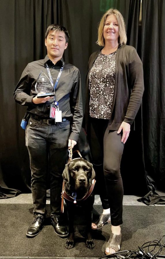 Seyoon Choi at the award cermony with his service dog, Kaplan