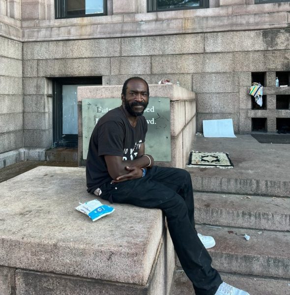 Christopher Perry sits on the steps of St. Louis City Hall (Photo by Gabrielle Chiodo)