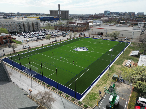 Students play soccer and lacrosse on the Vandeventer Field on March 20. With a $1.3 millon dollar renovation, the field has new lighting, turf and netting.
(Couretsy of Jack Herlihy).