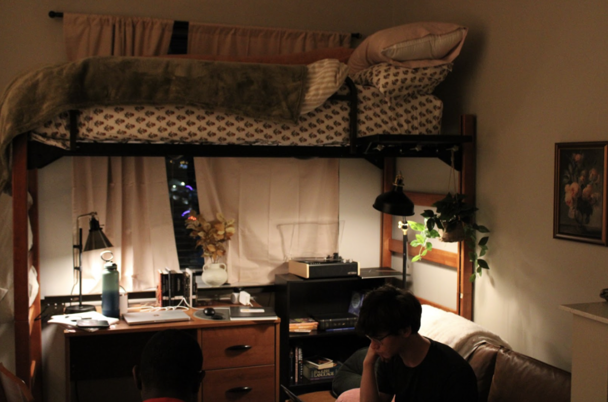 A photo of my bed in Spring Hall at Saint Louis University; notice the window placement, plants and ambient lighting. Placing your desk under a lofted
bed and in front of a window provides extra space within the dorm as well as providing ample light and aesthetics when both studying and relaxing. This
photo was taken Aug. 30, 2024.