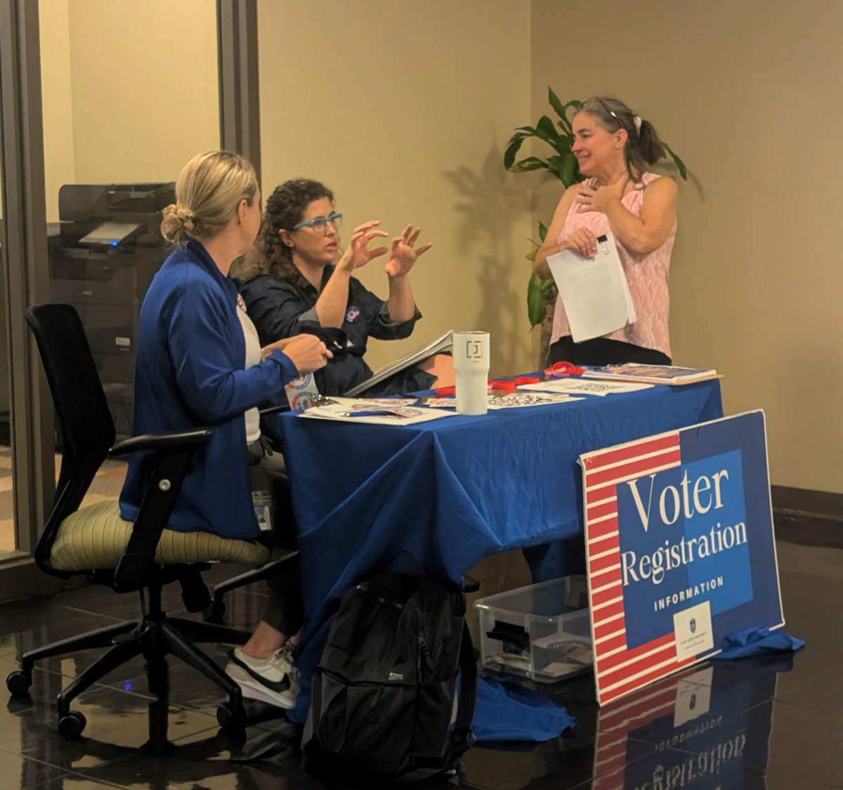 Staff with the Center for Social Action talk during a voter registration tabeling event at the Education Union on Saint Louis University’s South Campus on Sept. 16, 2024. 
