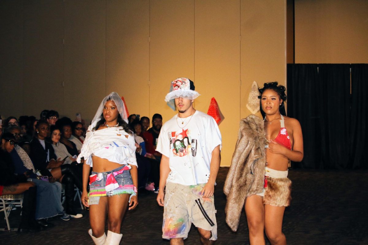 Lyric Smith, Sinesio Huezo and Simone Carter modeling for Lala’s Lair and walking out to “The Jump Off” by Lil’ Kim at Saint Louis University’s Busch Student Center on Nov. 17, 2024.