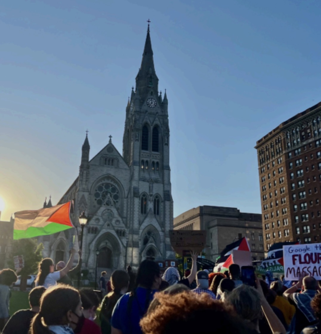 Protestors march in front of St. Francis Xavier College Church on May 1, 2024.