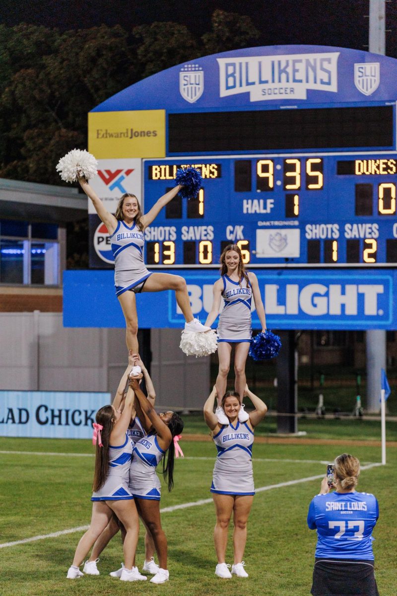 SLU cheer squad performing an impressive stunt at Billiken soccer match. 