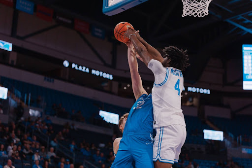 Freshman Amari McCottry rises up to block Rockhurst’s Dan Carr.