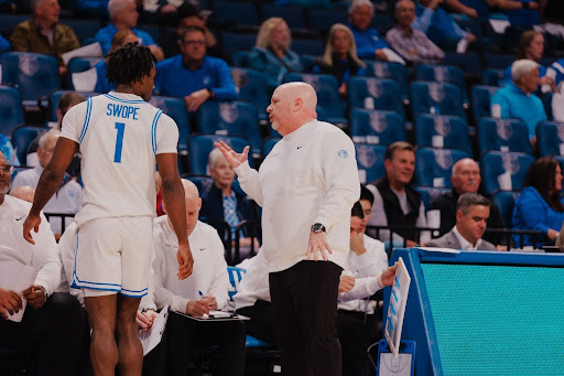 Josh Schertz coaches Isaiah Swope on the Billikens sideline.