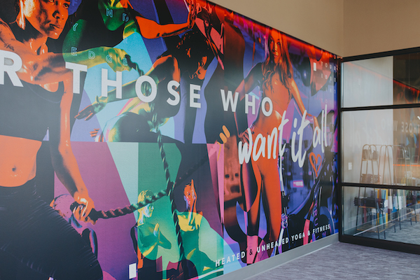 Mural saying “For those who want it all,” located at TruFusion Foundry’s entrance. 
(Photo Courtesy of City Foundry)
