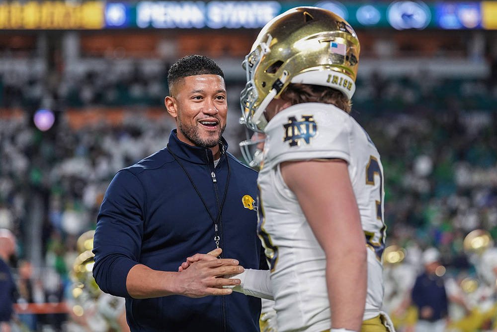 Notre Dame head coach Marcus Freeman with a player before the Orange Bowl College Football Playoff semifinal against Penn State on Jan. 9, 2025, in Miami Gardens, Florida. (AP/Rebecca Blackwell)