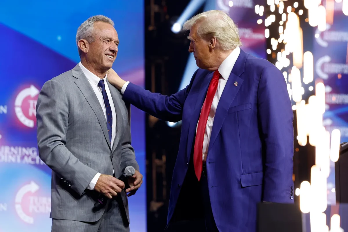 President Donald Trump and Robert F. Kennedy Jr. meeting onstage at a Turning Point USA rally in Georgia on Oct. 23, 2024. (Anna Moneymaker/Getty Images via Vox)
