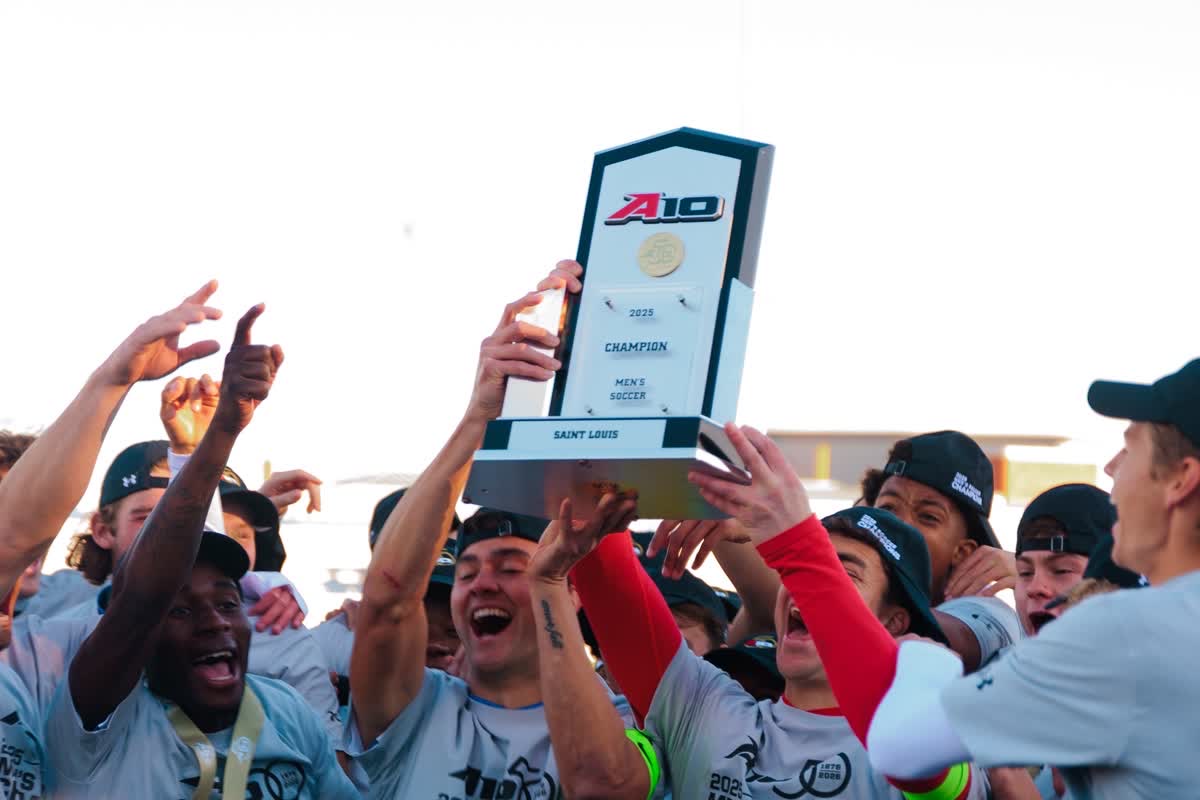 The Saint Louis University men's soccer raises the A-10 championship trophy following their win in Penalty Kicks against Dayton on Nov. 16 2025 at Hermann Stadium in St. Louis. 