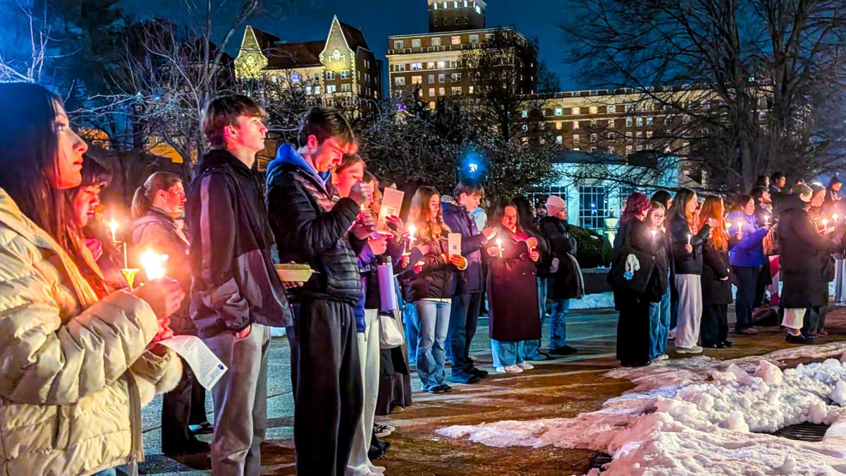 Students gather to light candles in front of the Clock Tower on Feb. 5, 2026 and mourn Renée Good, Alex Pretti and other people who were killed by ICE.