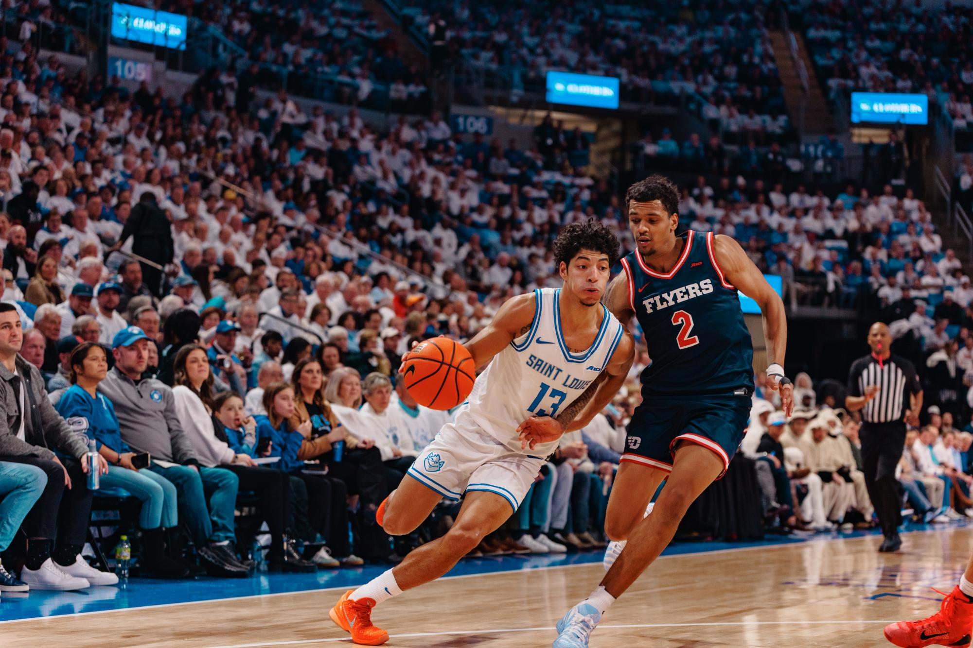 Senior guard Dion Brown, No. 13, drives past junior guard De'Shayne Montgomery, No. 2, in the annual "Billiken Blizzard" against the Dayton Flyers at Chaifetz Arena on Friday, Jan. 30, 2026.