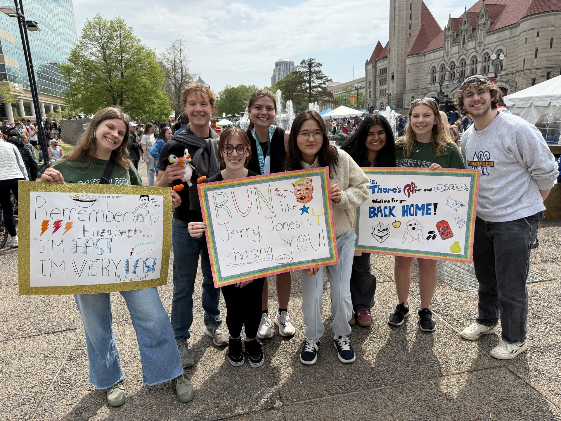 A group of Saint Louis University students display posters to cheer on friends running in the Greater St. Louis Marathon on Saturday, April 18, 2026. 